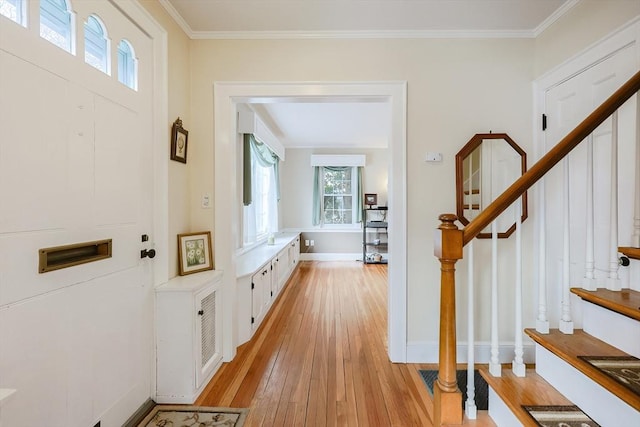 foyer featuring light hardwood / wood-style flooring and ornamental molding