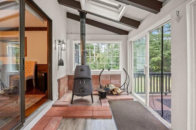 sunroom with lofted ceiling with skylight