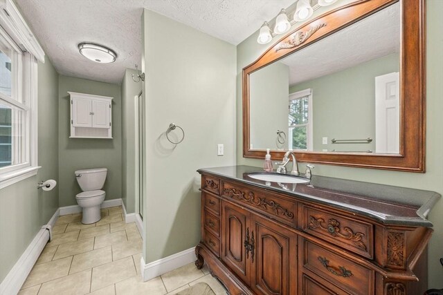 full bath featuring baseboards, toilet, tile patterned flooring, baseboard heating, and vanity