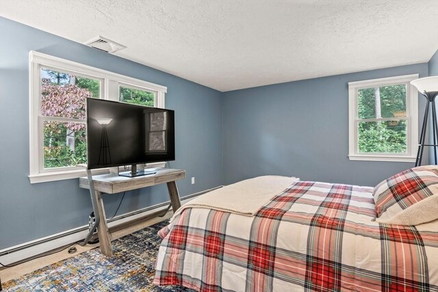 bedroom with visible vents, a textured ceiling, and multiple windows