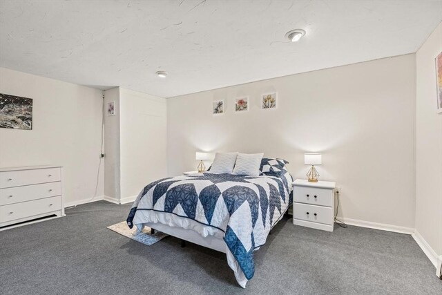 carpeted bedroom featuring baseboards