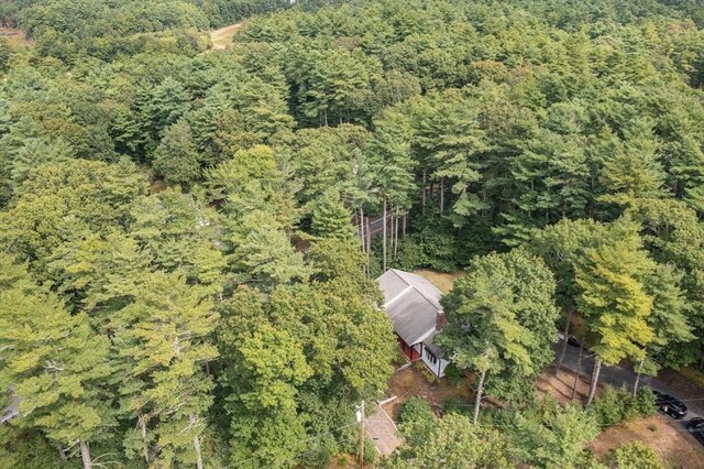 birds eye view of property featuring a view of trees