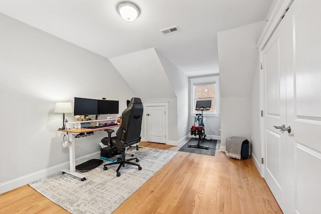 office with hardwood / wood-style flooring and lofted ceiling