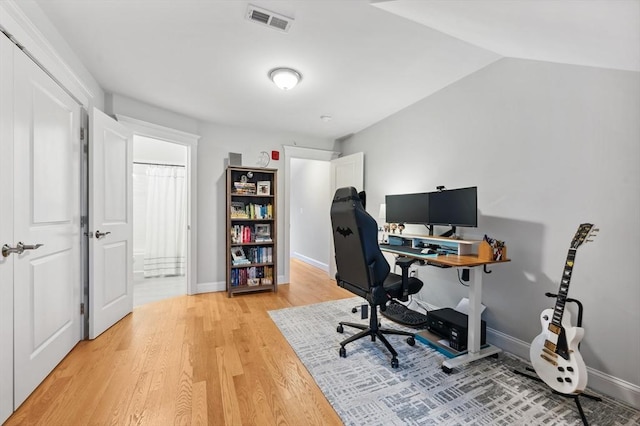 office area featuring hardwood / wood-style flooring and vaulted ceiling