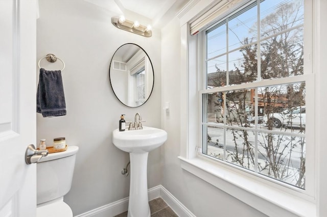 bathroom featuring toilet and tile patterned flooring