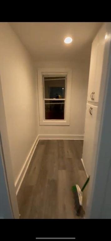 hallway with dark hardwood / wood-style flooring