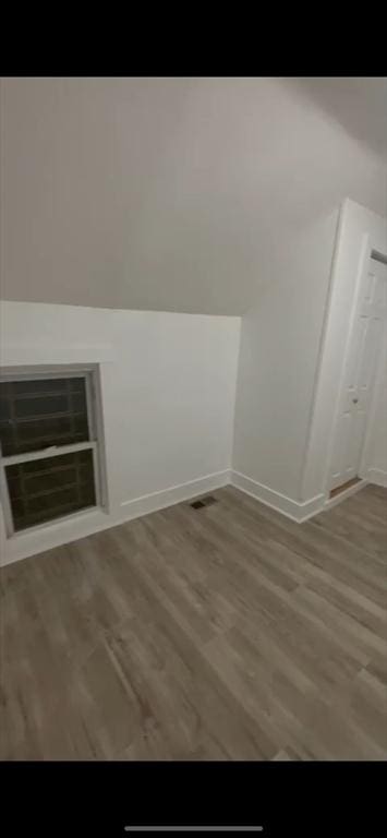 bonus room with hardwood / wood-style flooring