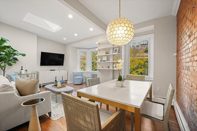 dining room featuring a skylight, baseboard heating, dark hardwood / wood-style flooring, brick wall, and beam ceiling