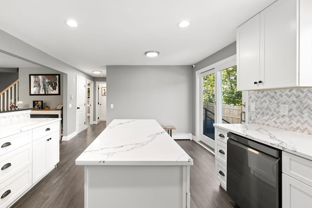 kitchen with a kitchen island, dark hardwood / wood-style floors, and light stone countertops