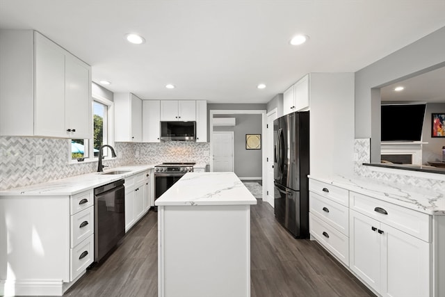 kitchen featuring white cabinetry, light stone counters, sink, dark hardwood / wood-style floors, and appliances with stainless steel finishes