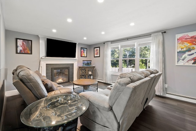 living room with a baseboard heating unit, a fireplace, and dark hardwood / wood-style floors