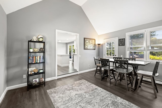 dining space with plenty of natural light, dark hardwood / wood-style floors, and high vaulted ceiling