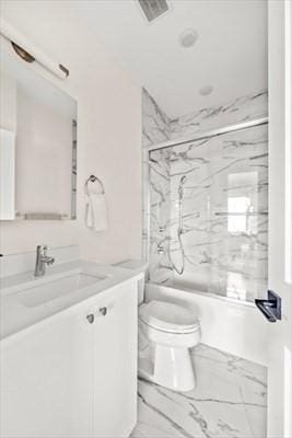 303 Maverick St Ph, Ph, Boston, MA 02128 - bathroom featuring visible vents, toilet, vanity, shower / bath combination with glass door, and marble finish floor