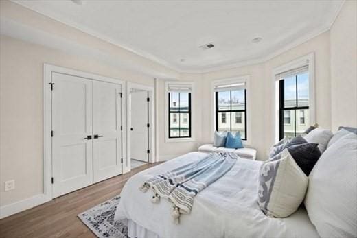 303 Maverick St Ph, Ph, Boston, MA 02128 - bedroom featuring ornamental molding, baseboards, and wood finished floors