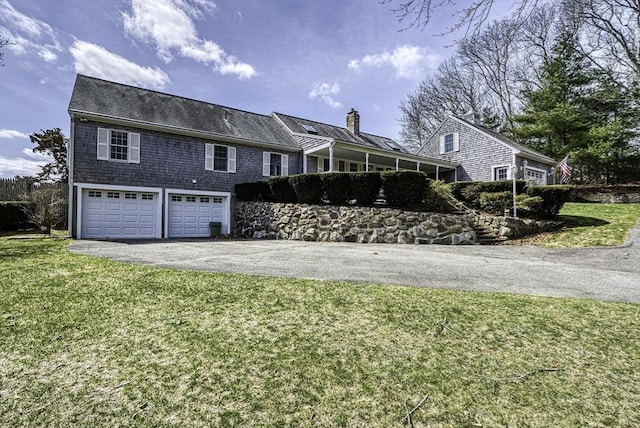 31 Baxendale Rd, Bourne, MA 02532 - view of front of house featuring an attached garage, a chimney, aphalt driveway, and a front yard