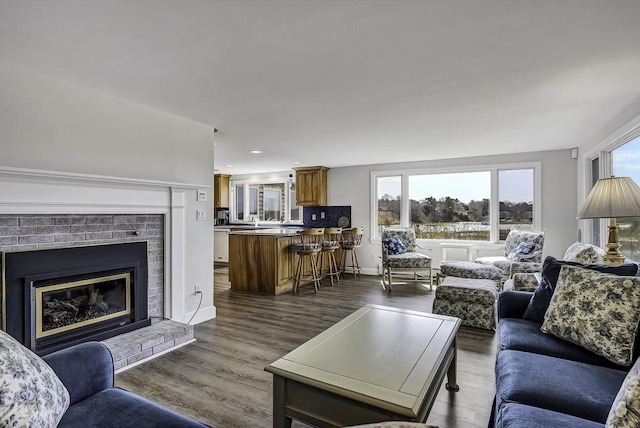 31 Baxendale Rd, Bourne, MA 02532 - living room with dark wood-type flooring, baseboards, recessed lighting, and a fireplace