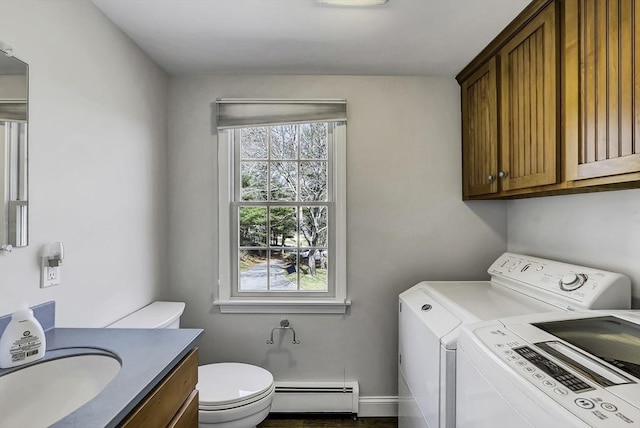 31 Baxendale Rd, Bourne, MA 02532 - laundry area with laundry area, baseboard heating, washing machine and clothes dryer, a sink, and baseboards