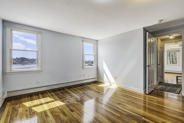 31 Baxendale Rd, Bourne, MA 02532 - spare room featuring a baseboard radiator, plenty of natural light, and wood finished floors