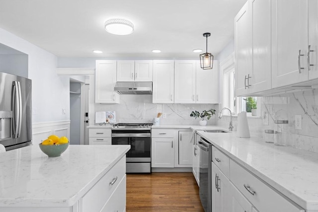 kitchen featuring stainless steel appliances, white cabinetry, and under cabinet range hood