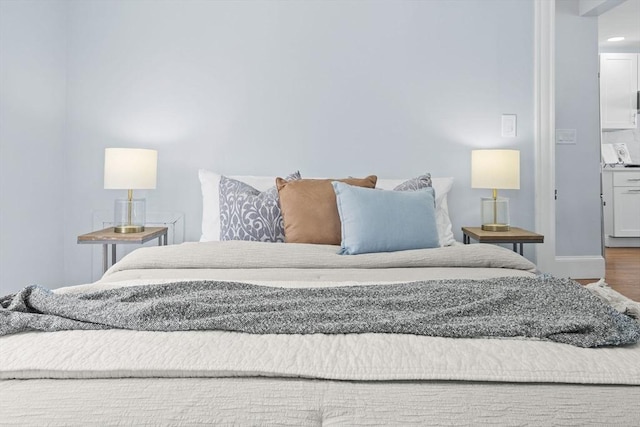 bedroom with baseboards and wood finished floors