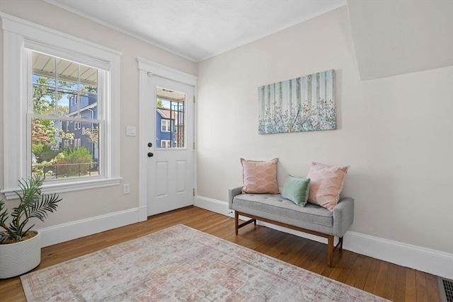 foyer entrance with baseboards and wood finished floors