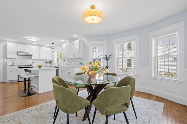 dining room featuring baseboards, recessed lighting, and wood finished floors