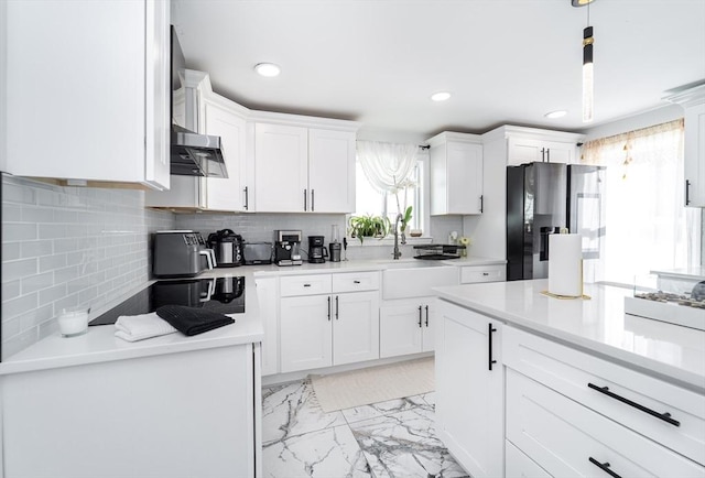 kitchen featuring marble finish floor, white cabinets, light countertops, and stainless steel fridge with ice dispenser