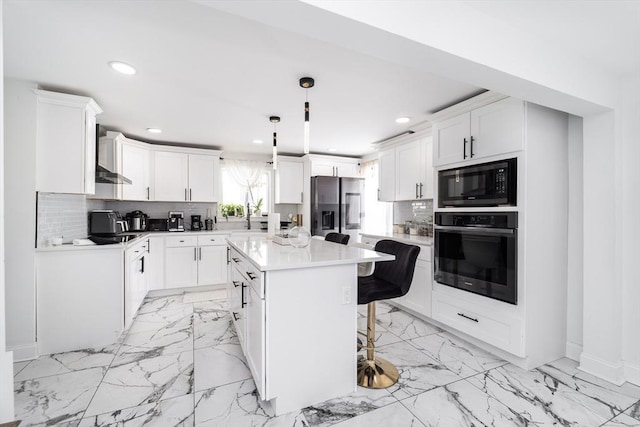 kitchen featuring recessed lighting, white cabinets, a center island, black appliances, and tasteful backsplash