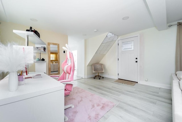 interior space with washer / clothes dryer, wood finished floors, and baseboards