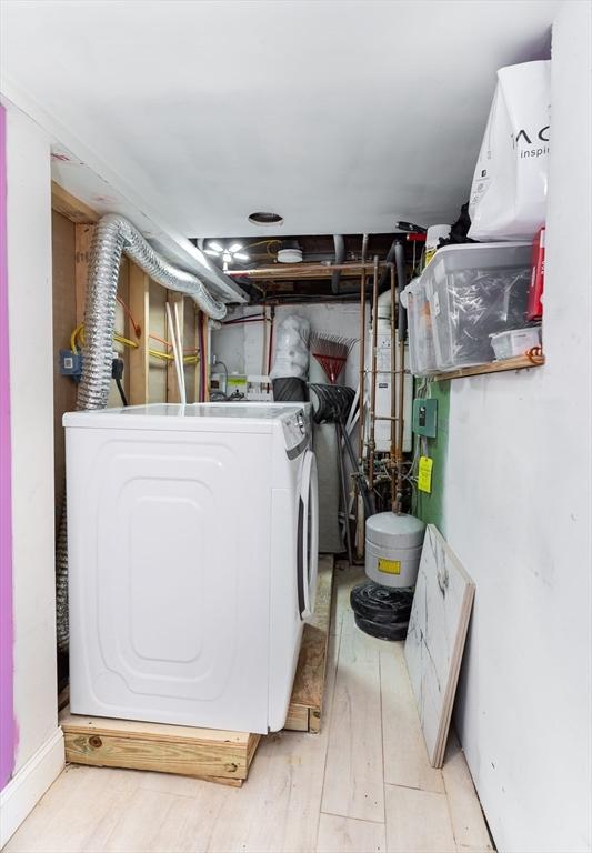 laundry room with laundry area, washer / clothes dryer, and light wood finished floors