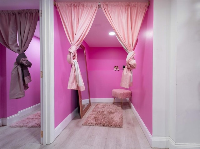 bathroom with wood finished floors and baseboards