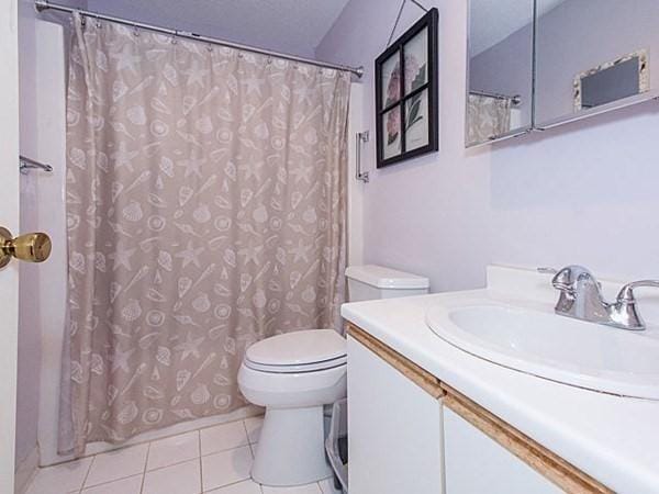 bathroom with vanity, toilet, and tile patterned flooring