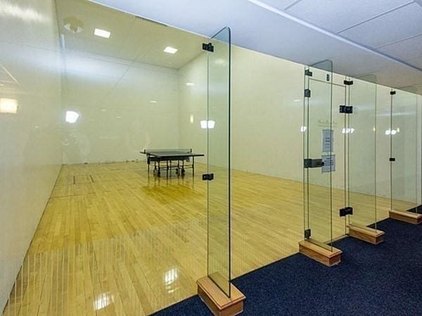 interior space with an enclosed shower and hardwood / wood-style floors