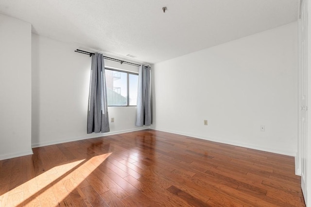 spare room featuring hardwood / wood-style flooring