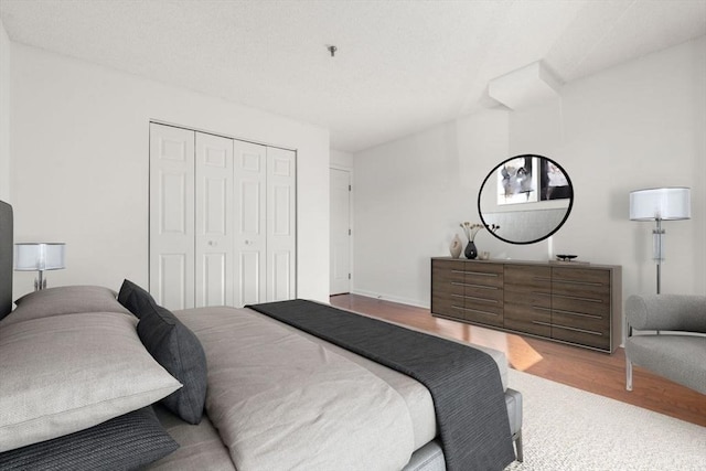 bedroom with hardwood / wood-style floors and a closet