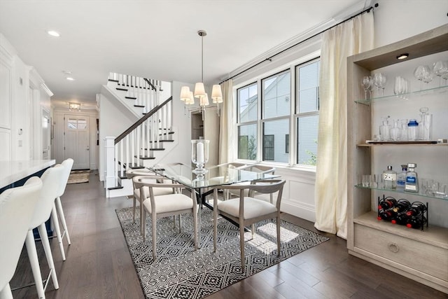 dining area with dark wood-style floors, recessed lighting, stairway, and an inviting chandelier