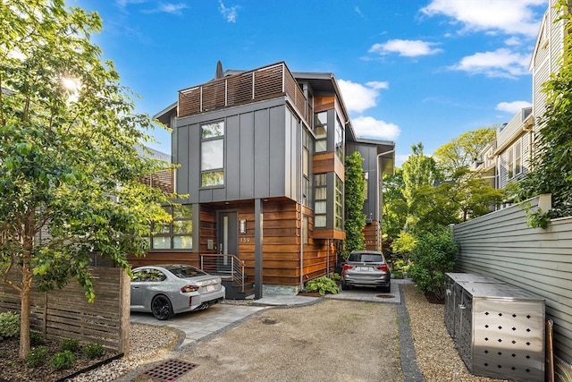137 Walden St Unit 137, Cambridge, MA 02140 - rear view of property with board and batten siding