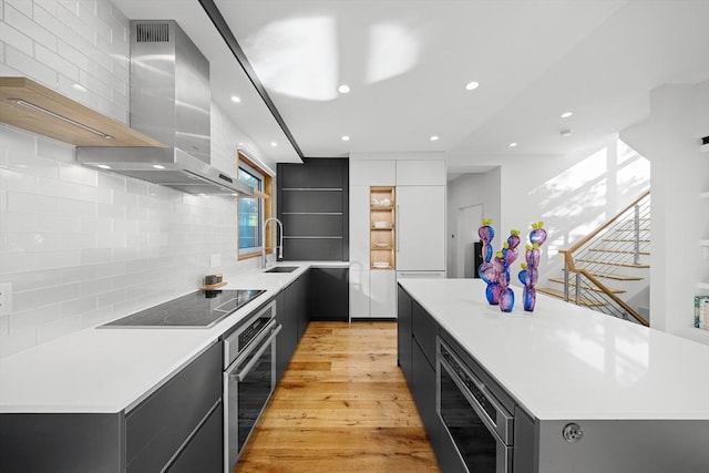 137 Walden St Unit 137, Cambridge, MA 02140 - kitchen with appliances with stainless steel finishes, open shelves, modern cabinets, wall chimney range hood, and recessed lighting