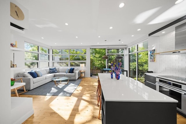 137 Walden St Unit 137, Cambridge, MA 02140 - kitchen with stainless steel oven, a kitchen island, healthy amount of natural light, light countertops, and recessed lighting