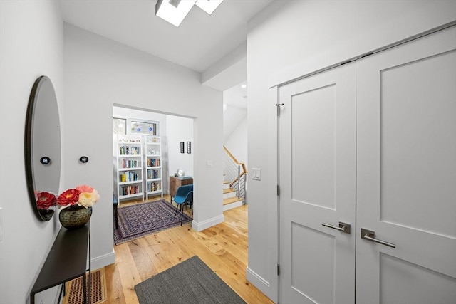 137 Walden St Unit 137, Cambridge, MA 02140 - corridor with light wood-style flooring, stairs, and baseboards