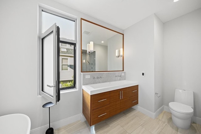 137 Walden St Unit 137, Cambridge, MA 02140 - full bath with vanity, baseboards, a freestanding bath, and toilet