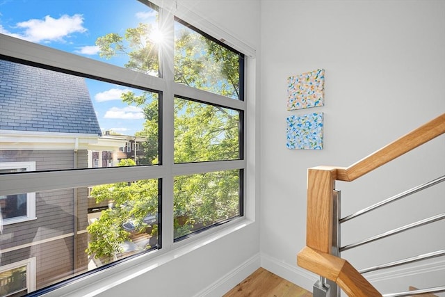 137 Walden St Unit 137, Cambridge, MA 02140 - stairs featuring baseboards, wood finished floors, and plenty of natural light