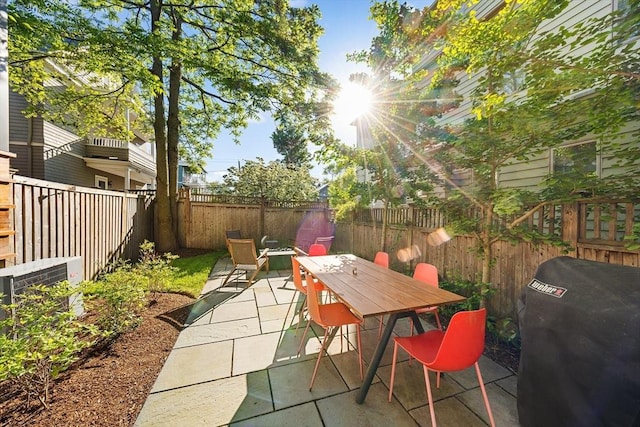 137 Walden St Unit 137, Cambridge, MA 02140 - fenced backyard featuring a patio, grilling area, and outdoor dining area