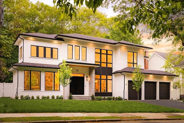 95 Blake St, Newton, MA 02460 - view of front facade with asphalt driveway, a garage, and stucco siding