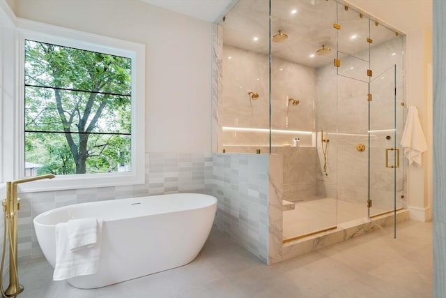 95 Blake St, Newton, MA 02460 - bathroom with tile walls, a marble finish shower, a freestanding bath, tile patterned flooring, and wainscoting