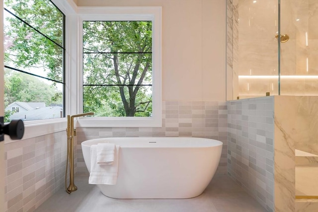 95 Blake St, Newton, MA 02460 - full bath featuring tile walls, a soaking tub, healthy amount of natural light, and wainscoting