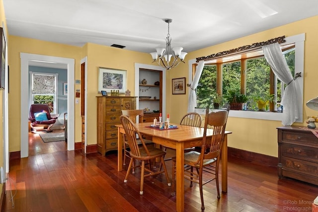 11 Hickory St, Gloucester, MA 01930 - dining area featuring a chandelier and dark wood-style flooring