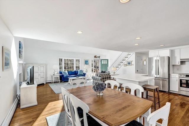 dining space with stairs, recessed lighting, dark wood finished floors, and a baseboard radiator