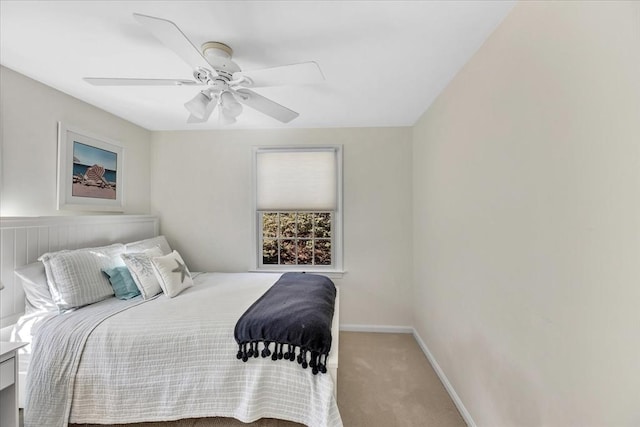 bedroom with a ceiling fan, baseboards, and carpet floors