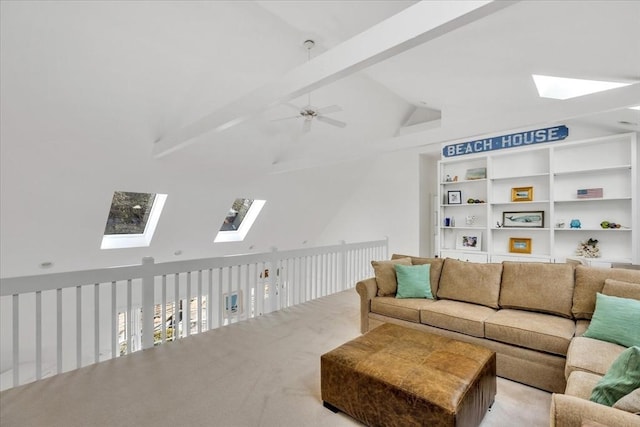 living room with lofted ceiling with skylight, light colored carpet, and a ceiling fan